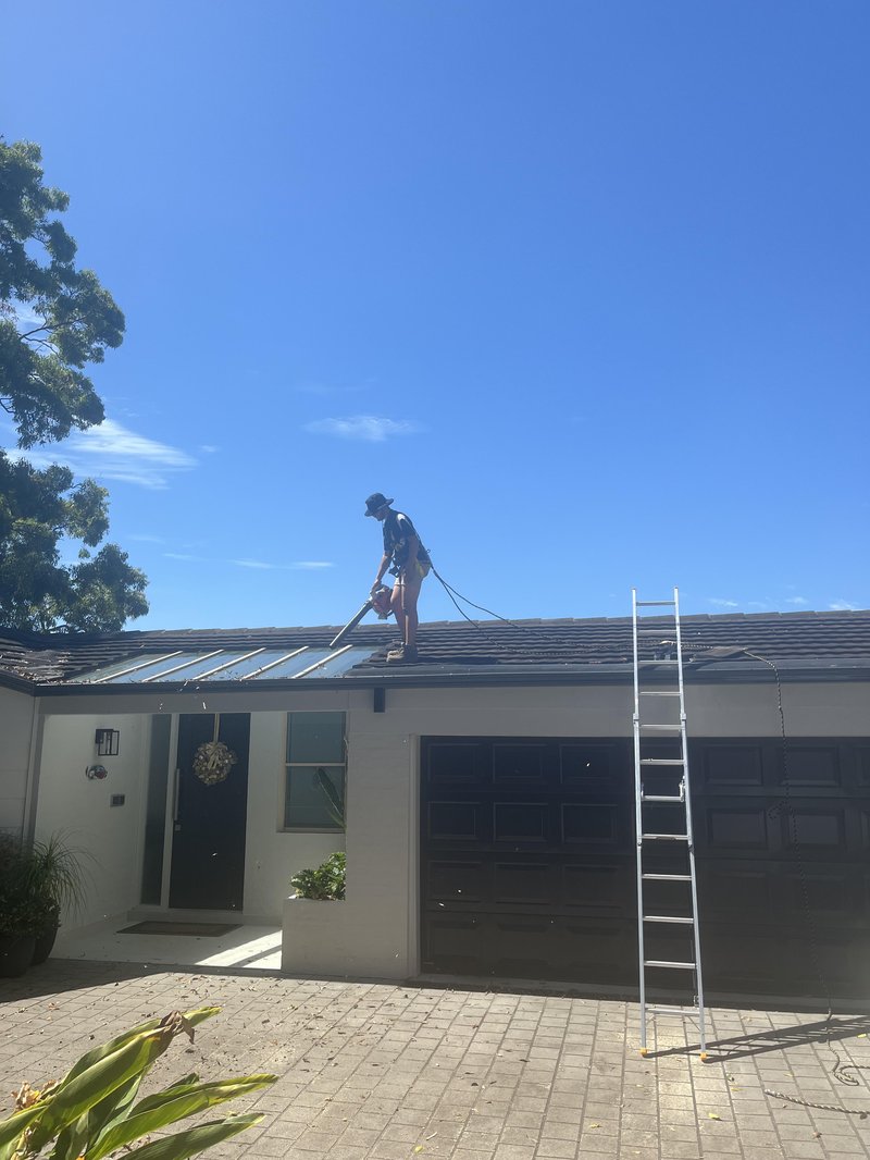 Adin from A & J Exterior working on a roof